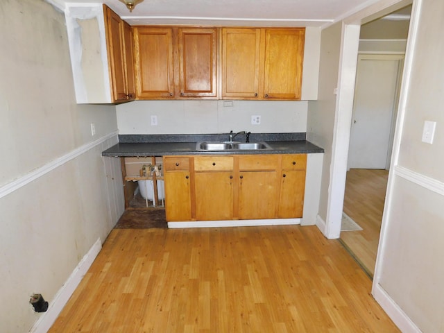 199 Caney Creek Rd, Stamping Ground, KY 40379 - kitchen featuring a sink, dark countertops, brown cabinets, and light wood finished floors