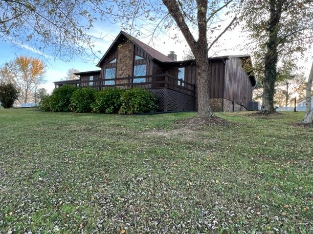 view of side of property with a yard