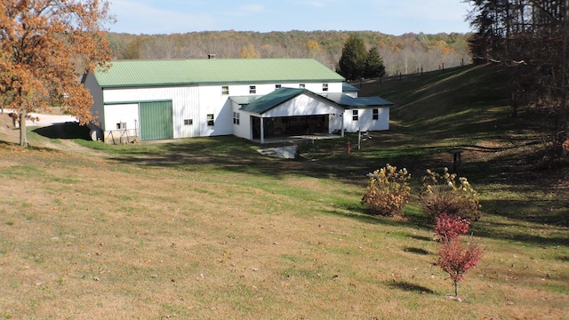 rear view of house featuring a yard