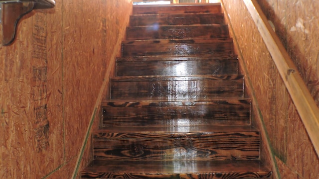 staircase with wooden walls