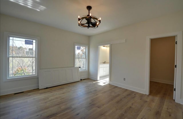 interior space featuring a notable chandelier, radiator, and light hardwood / wood-style flooring