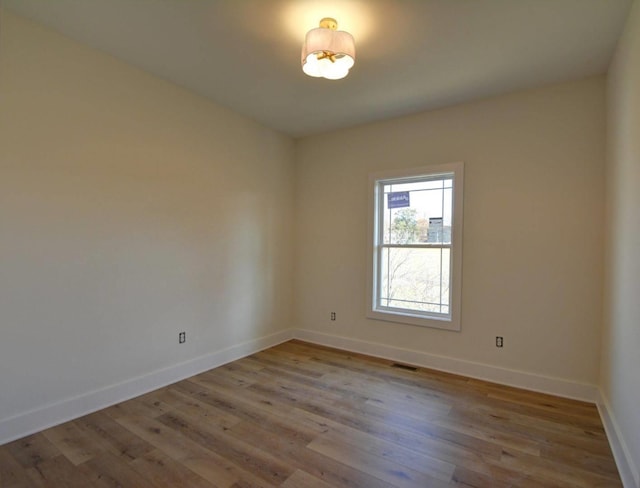 spare room featuring light hardwood / wood-style flooring