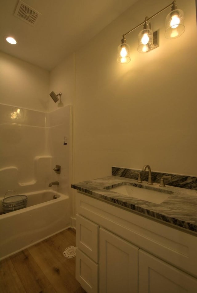 bathroom featuring shower / tub combination, vanity, and hardwood / wood-style flooring