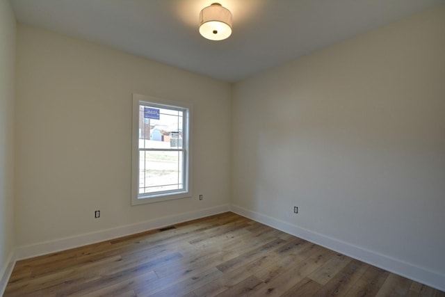 spare room featuring light wood-type flooring