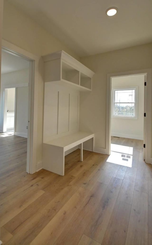 mudroom with light hardwood / wood-style floors