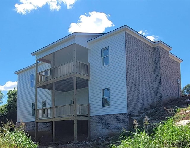 rear view of property featuring a balcony