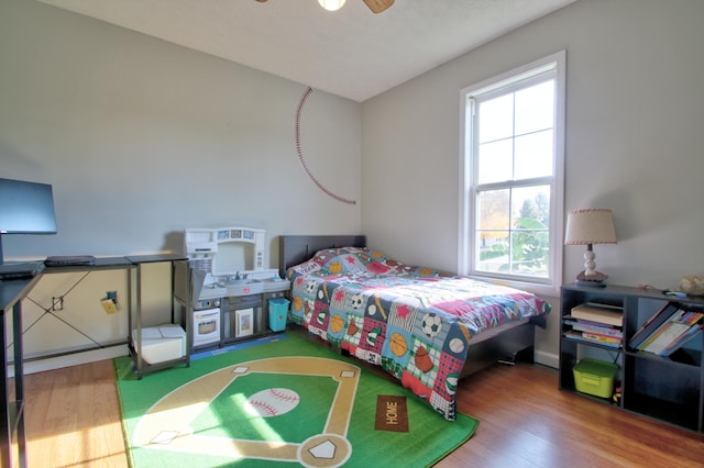 bedroom featuring wood-type flooring and ceiling fan