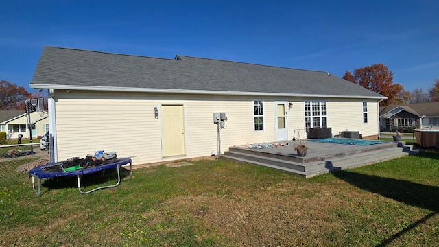 rear view of property featuring a yard, central AC, and a wooden deck