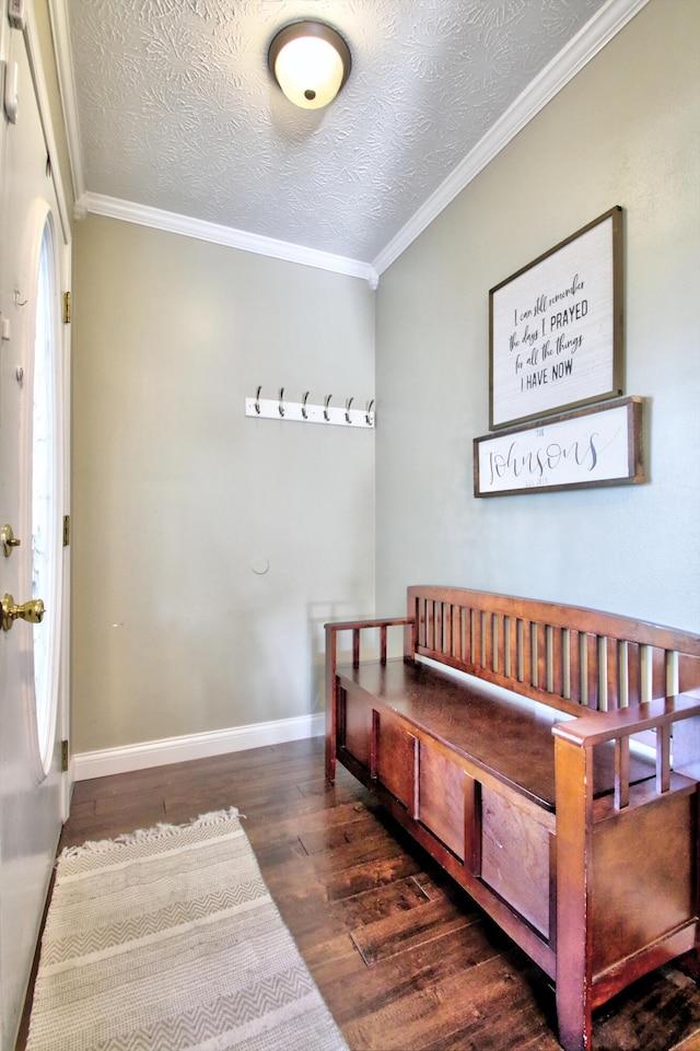 interior space with a textured ceiling, ornamental molding, and dark hardwood / wood-style flooring