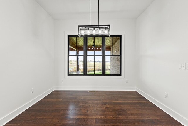 kitchen featuring light stone counters, ceiling fan, beam ceiling, and a stone fireplace