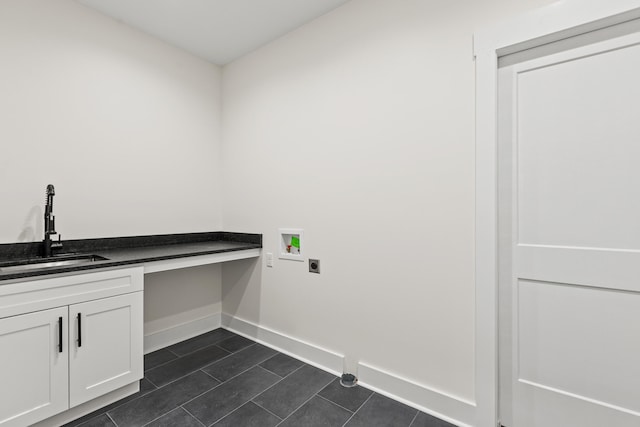 washroom featuring sink, hookup for a washing machine, cabinets, dark tile patterned flooring, and hookup for an electric dryer