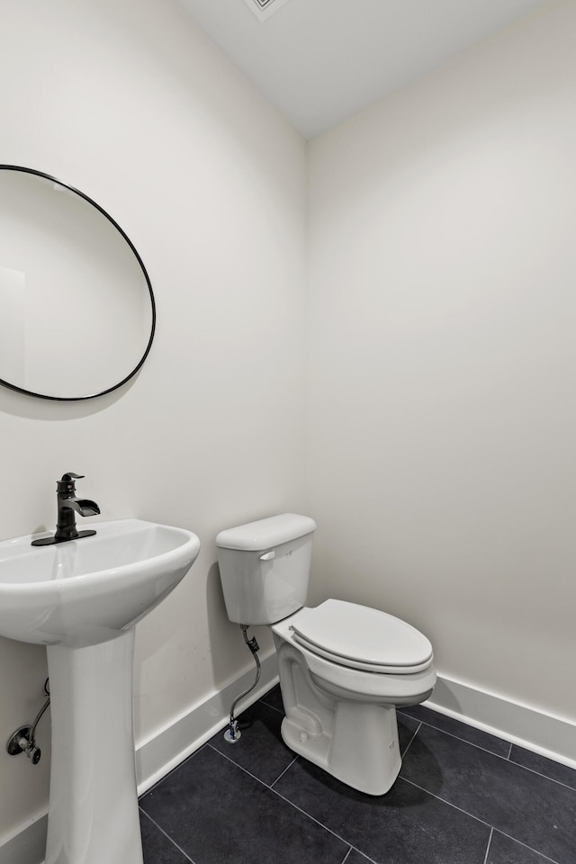 bathroom featuring sink, tile patterned floors, and toilet