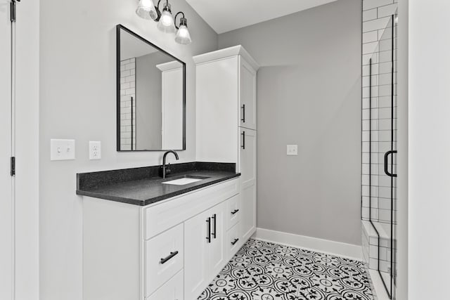 bathroom with walk in shower, tile patterned floors, and vanity