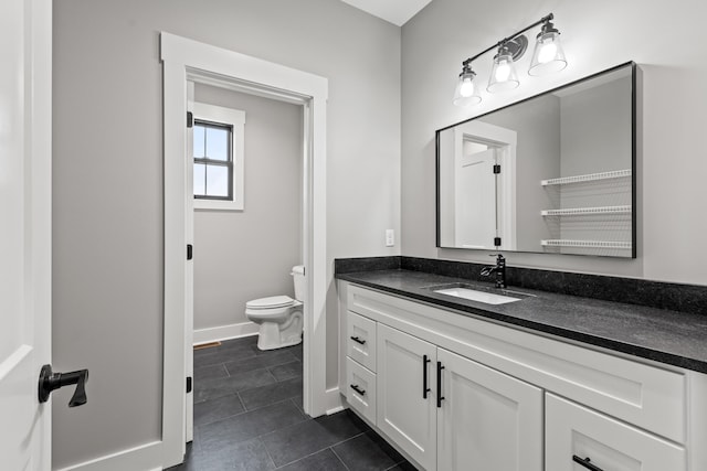 bathroom featuring tile patterned floors, vanity, and toilet