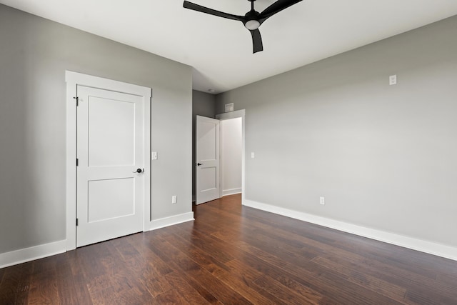 unfurnished bedroom with ceiling fan and dark hardwood / wood-style floors