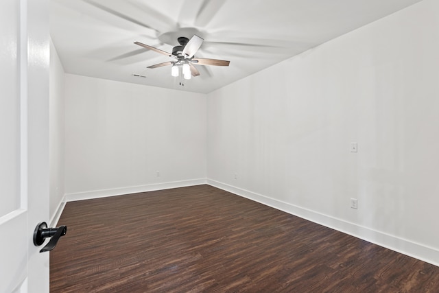 spare room with dark hardwood / wood-style floors and ceiling fan