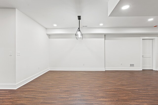 empty room with ceiling fan and dark hardwood / wood-style flooring