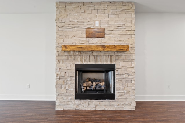 interior details featuring hardwood / wood-style flooring and a stone fireplace