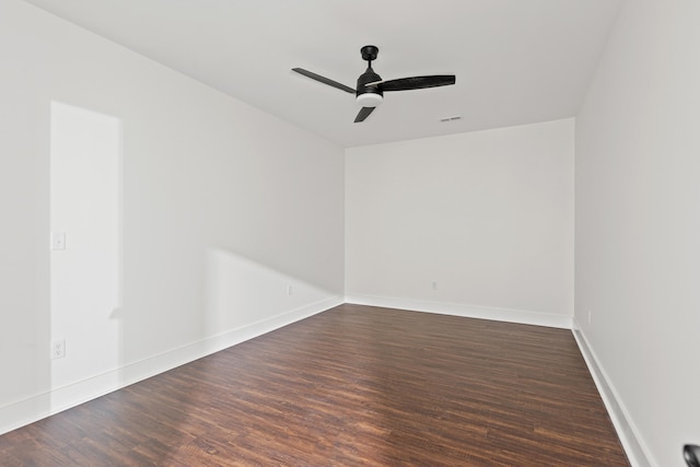 spare room with dark hardwood / wood-style flooring and ceiling fan