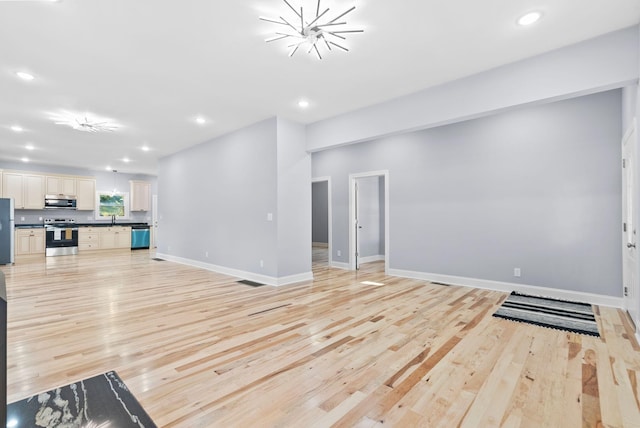 living room featuring light hardwood / wood-style floors and sink