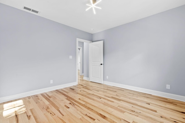 empty room with light hardwood / wood-style flooring