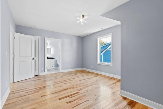 empty room with light hardwood / wood-style flooring