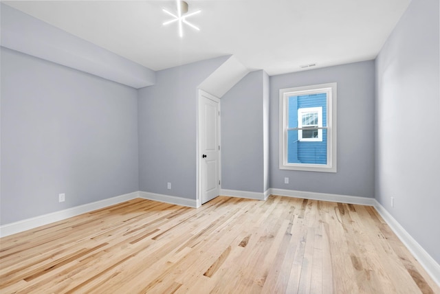 additional living space featuring light wood-type flooring