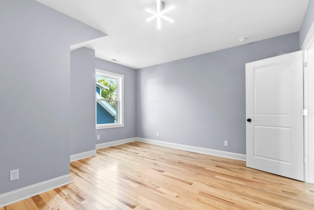 spare room with light wood-type flooring