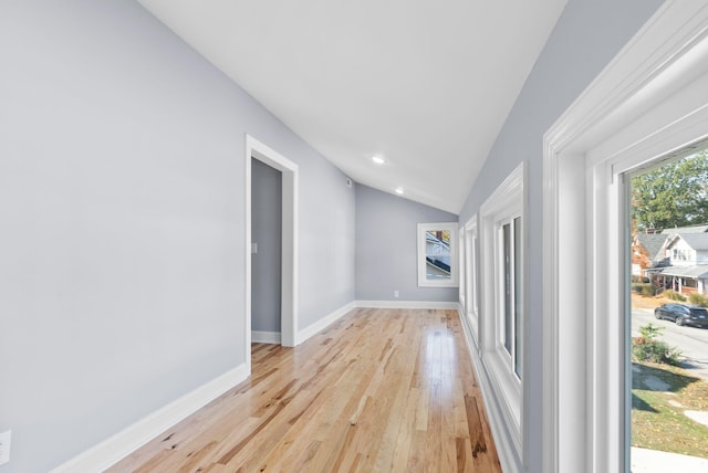 unfurnished living room with light hardwood / wood-style flooring and lofted ceiling