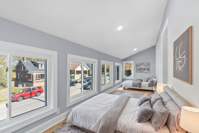 bedroom with lofted ceiling and hardwood / wood-style floors