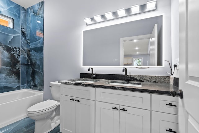 full bathroom featuring vanity, tiled shower / bath combo, and toilet