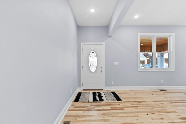 entryway featuring beam ceiling and hardwood / wood-style floors