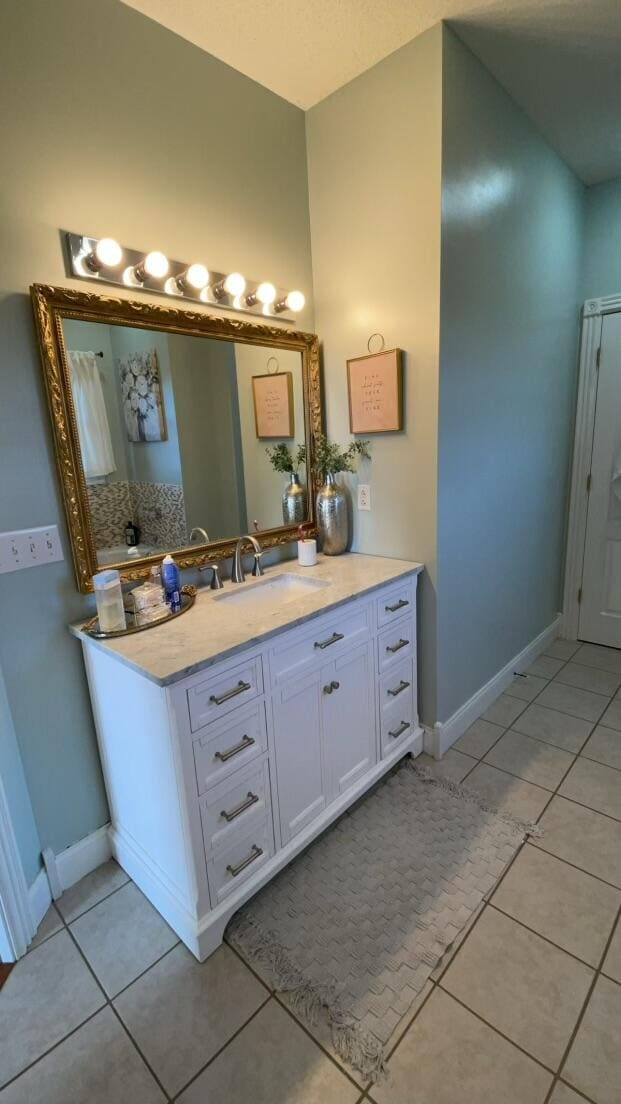 bathroom with tile patterned flooring and vanity