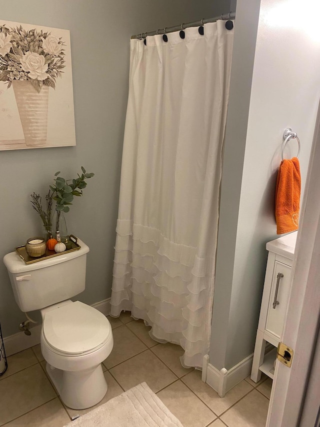 bathroom featuring tile patterned floors, curtained shower, vanity, and toilet