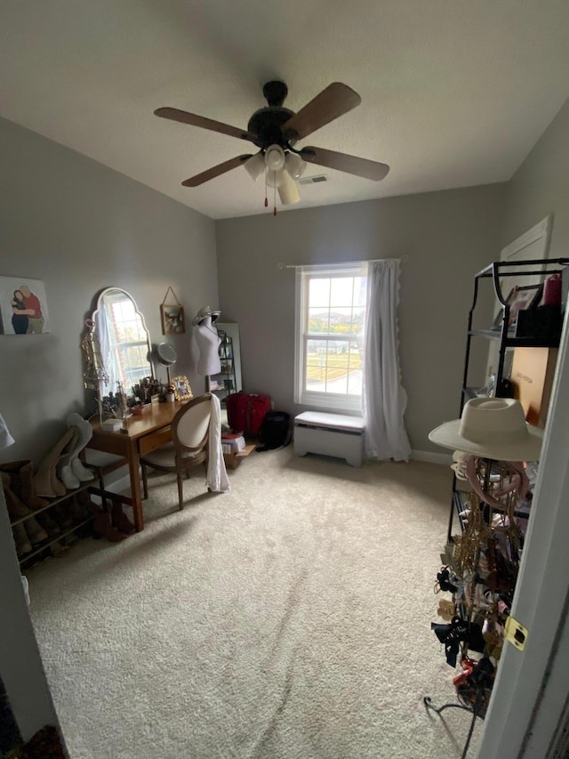 interior space featuring carpet and ceiling fan