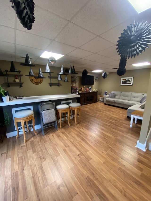 interior space with hardwood / wood-style flooring and a drop ceiling