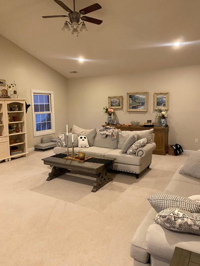 living room featuring ceiling fan, lofted ceiling, and light carpet