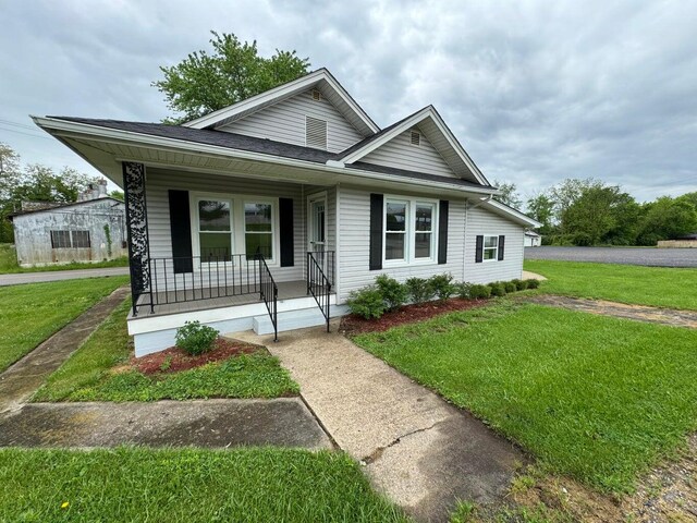 view of front of home featuring covered porch and a front yard