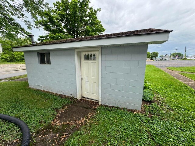 view of outbuilding featuring a yard