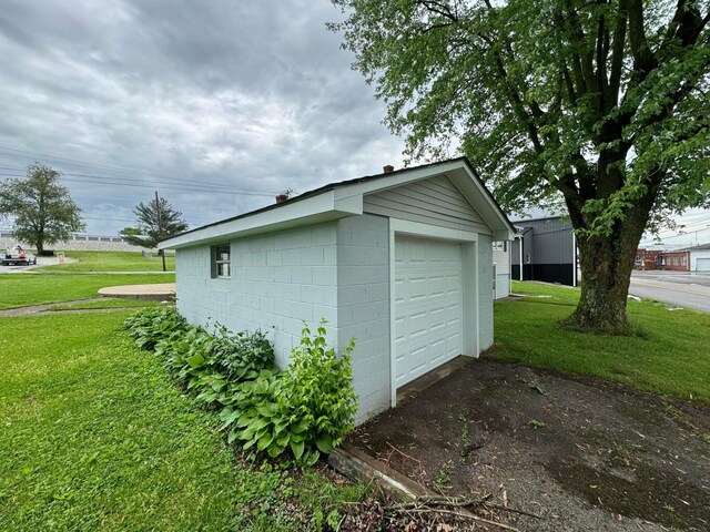 garage featuring a lawn