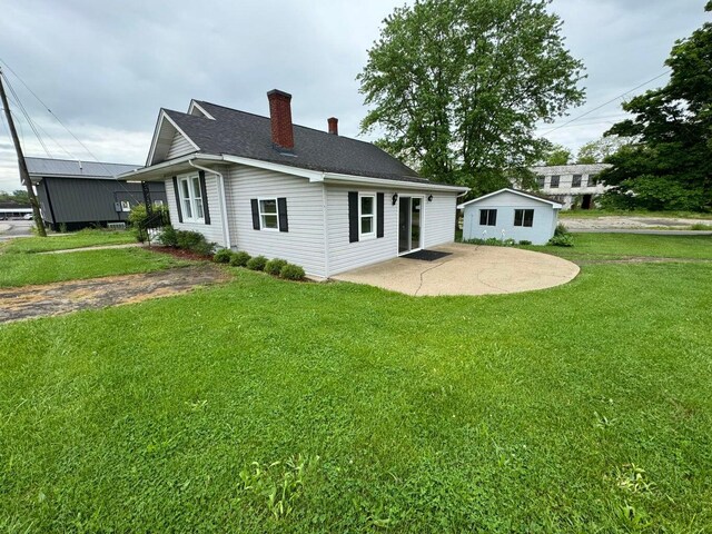 back of house featuring a yard and a patio area