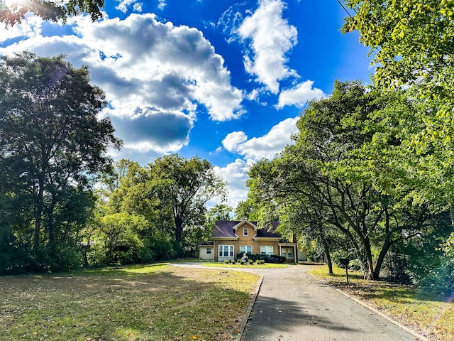 view of front of home with a front yard and driveway