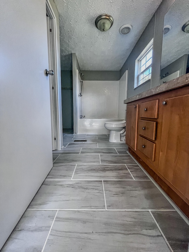 bathroom with toilet, vanity, wood-type flooring, and a textured ceiling