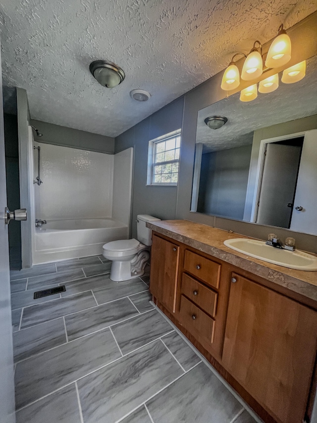 full bathroom with washtub / shower combination, vanity, a textured ceiling, and toilet