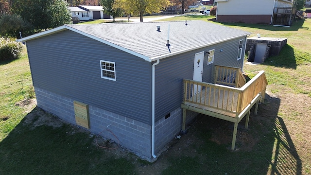 back of property featuring a yard and a wooden deck