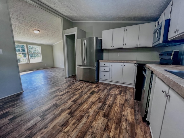 kitchen featuring white cabinetry, lofted ceiling, and stainless steel appliances