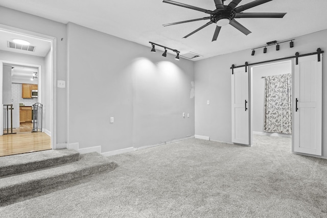 223 Sycamore Rd, Stanton, KY 40380 - empty room with rail lighting, a barn door, visible vents, ceiling fan, and carpet floors