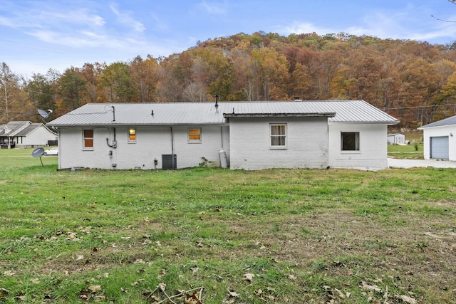 223 Sycamore Rd, Stanton, KY 40380 - rear view of property with a lawn, metal roof, a view of trees, and brick siding