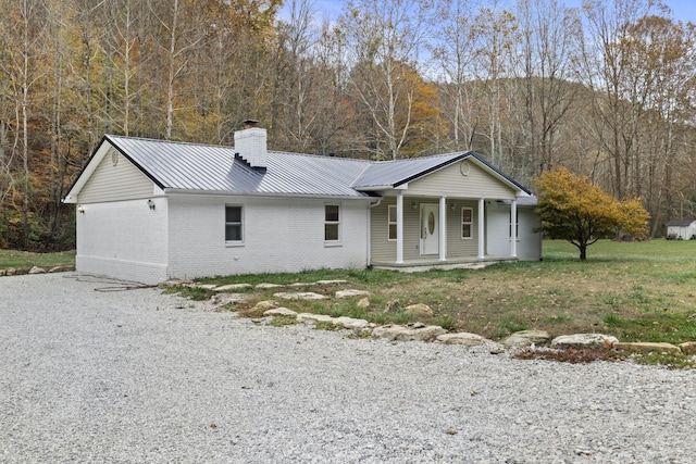223 Sycamore Rd, Stanton, KY 40380 - view of front of house featuring a chimney, metal roof, a porch, and brick siding