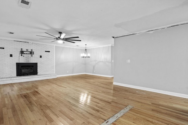 223 Sycamore Rd, Stanton, KY 40380 - unfurnished living room featuring ceiling fan with notable chandelier, visible vents, crown molding, baseboards, and light wood-style floors